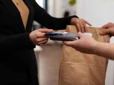 Close up of business woman holding credit card of pos